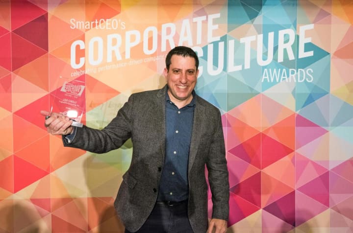Robert Patterson, director of Sales and Marketing at Progressive Computing in Yonkers shows off the company&#x27;s SmartCEEO Award the company recently won for having a positive, productive workplace.