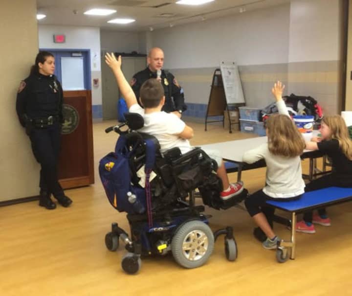 Police Officer Cheryl Jarosz and Sgt. William Carroll talk to Bronxville Elementary School students about safety on Halloween. 