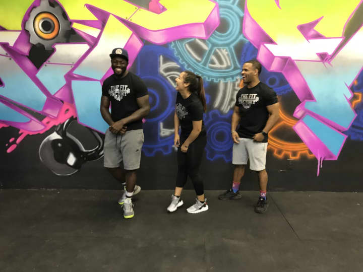 Jessi Corredor, center, Tarrant Anderson, right and Michael Gee, left, the owners of The Fit Factory in Englewood.