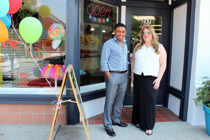 Holly Sharpe and Hossain Ahmed outside their candy store, Pop Culture, in Harrison.