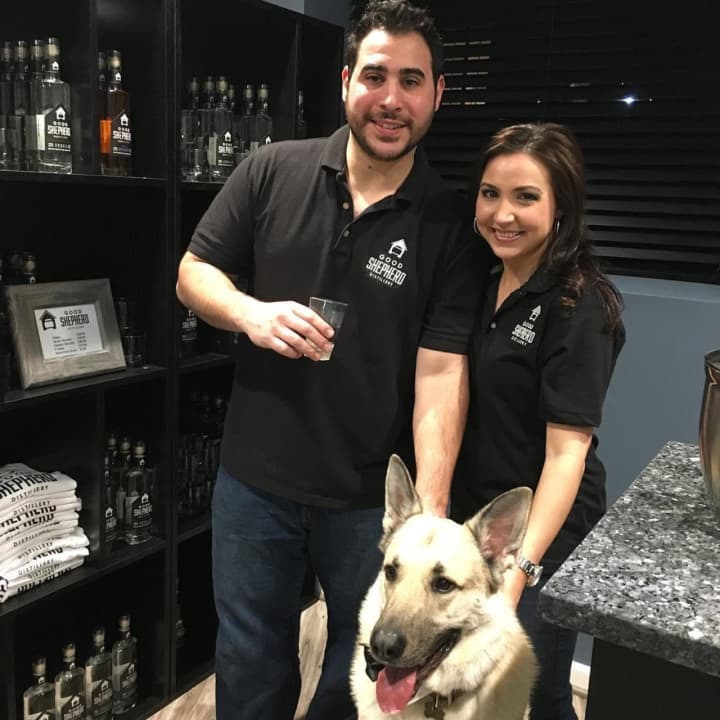 Good Shepherd Distillery Owners Vinny and Carly Miata with their dog, Loki.