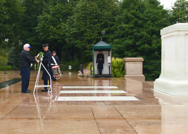 New Rochelle resident Martin J Cassidy places a wreath at the Tomb of the Unknown Soldier.