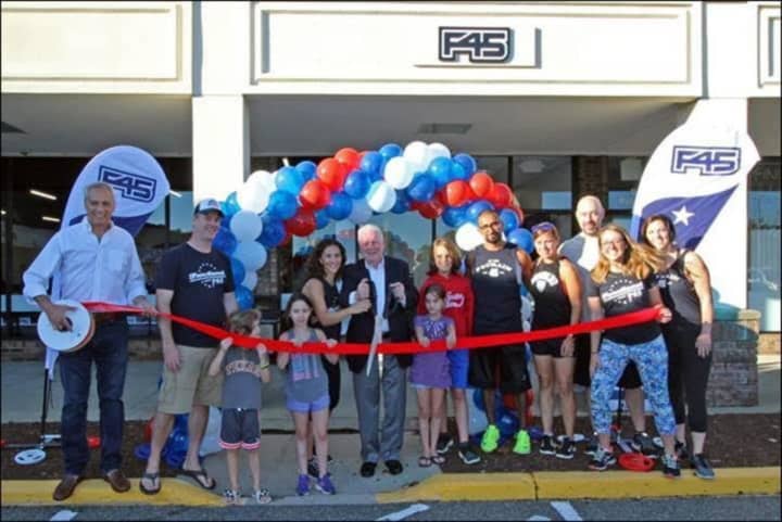 Fairfield First Selectman Mike Tetreau cuts the ribbon at the grand opening celebration at F45 Fairfield USA. See story for IDs.