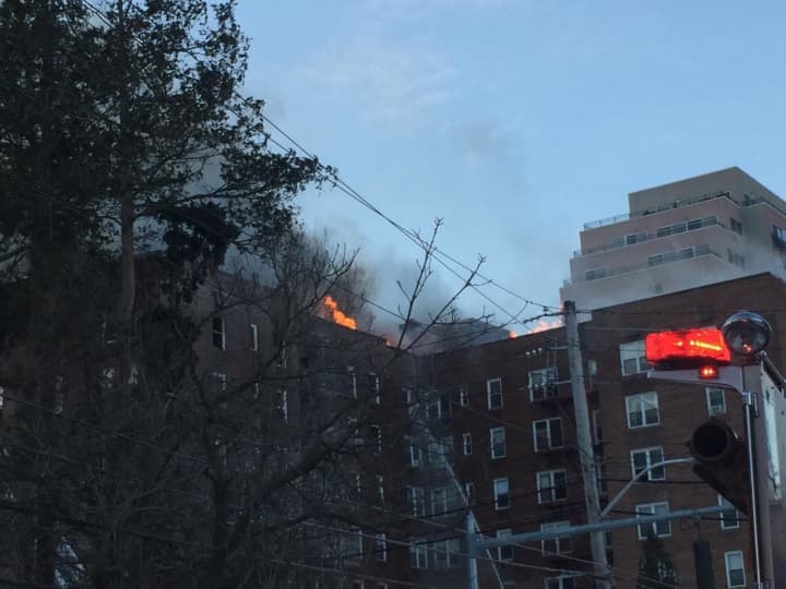 Firefighters from New Rochelle are offering an assist to crews battling a four-alarm blaze at a Yonkers apartment building.