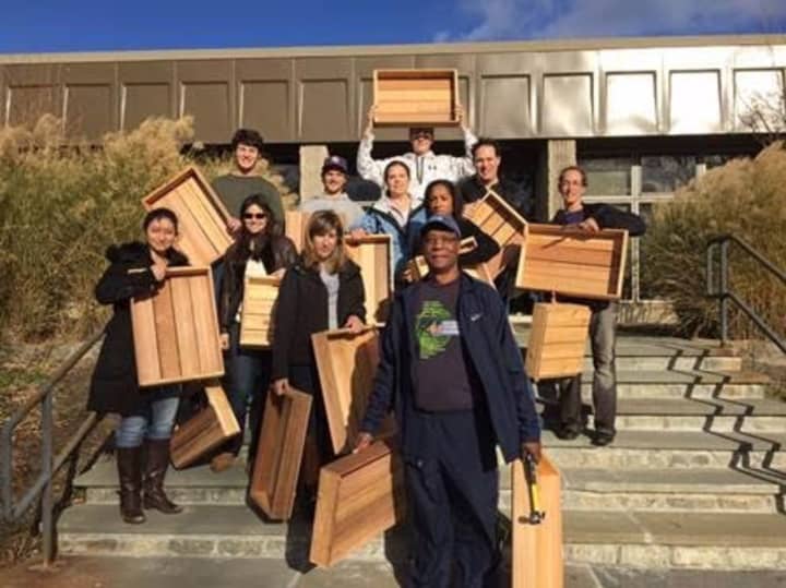 On Saturday, November 14th 2015: A team of volunteers hold finished planter boxes that they built for a greenhouse in Harrison, where they will be used to grow fresh winter produce for those in need.