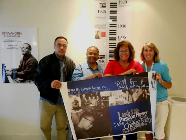 The panel for &quot;Strayhorn: An Illustrated Life,&quot; an exhibit celebrating the life of jazz pioneer Billy Strayhorn, is displayed by, from left, designer Jesse Sanchez; co-curators Leslie Demus and Theresa Kump Leghorn; and art teacher Laura Heiss.