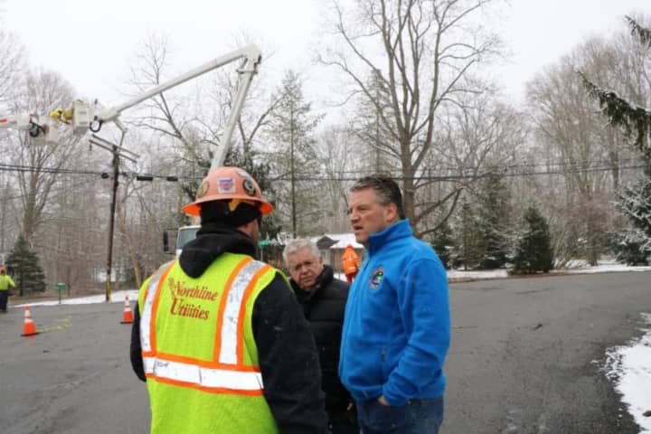 State Sen. Terrence Murphy and Somers Supervisor Rick Morrissey are briefed on power restoration efforts by a crew worker from Northline Utilities in Somers.