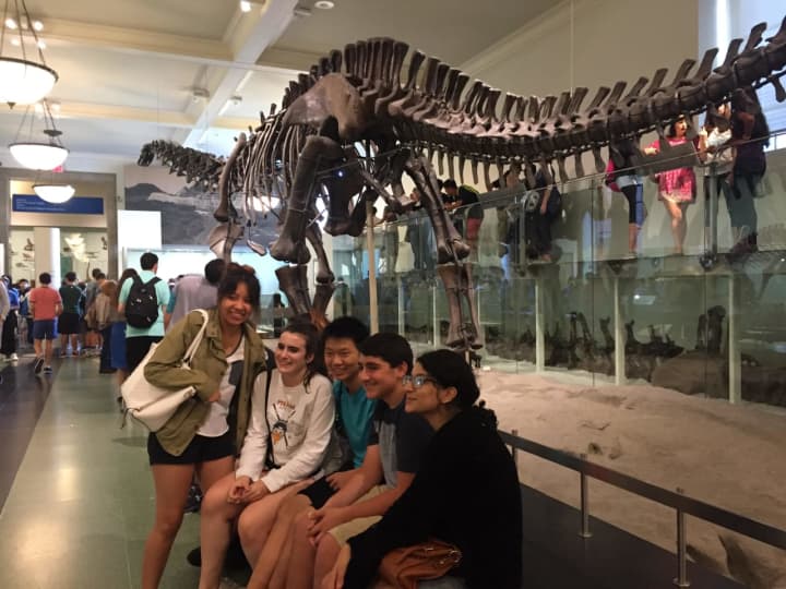 Pelham students pose in front of a dinosaur at the American Museum of Natural History on the recent field trip.