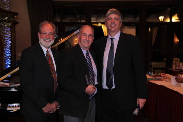 Pictured are David Freshwater, chairman Watermark Retirement Communities, and David Barnes, president and chief executive officer, presenting the award David Goldsmith.