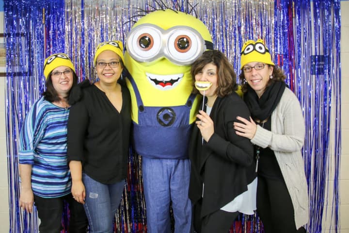 Lyncrest School fifth grade committee members (left to right) Jessica Tratner, Vivian Cardoso, Susan Quinlan and Alyssa Shacknow hang with special guest Bob the Minion in the photo booth.