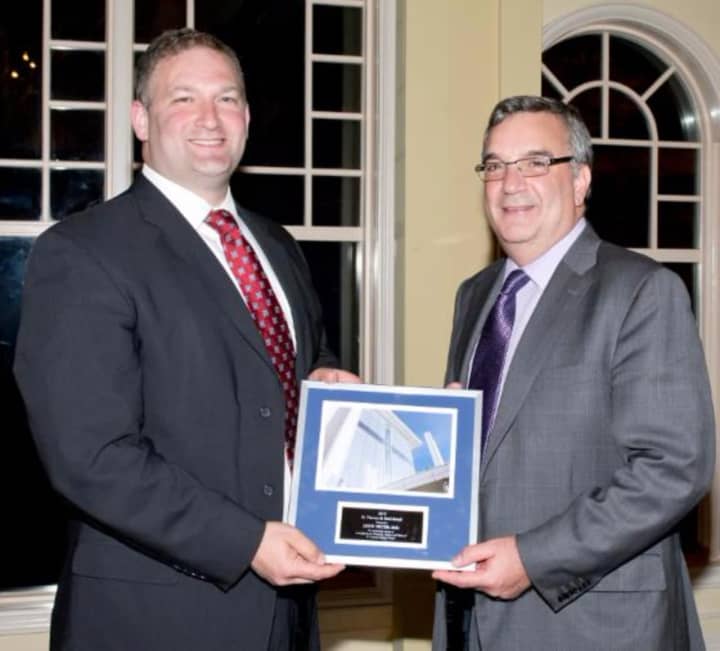 Dr. Jared Selter accepts the 2015 Physician of the Year Award from Stuart G. Marcus, president and CEO of St. Vincent&#x27;s Medical Center.