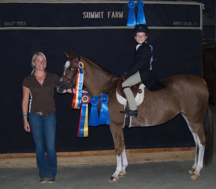Summit Farms owner Ashley Yozzo poses with 9-year-old Hayley Hewitt of New Canaan, Conn.,who recently won Horse of the Year competition.