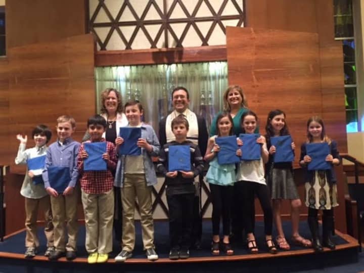 The third grade class from Temple Beth El receiving their Siddur.