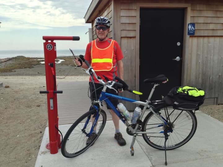 Tim Bezler of Fairfield examines the town’s new stainless steel, tamperproof Bicycle Repair and Air Pump Station at Southport Beach. A second station is in place at Brookside Park near Mill Plain Road.