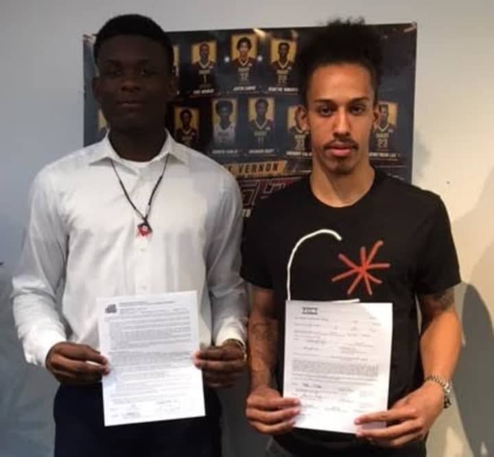 Gregory Calixte, left, and Noah Morgan show their signed letters of intent signed April 21. Calixte will attend George Mason University of Virginia and Morgan will attend Fairleigh Dickinson University in New Jersey.