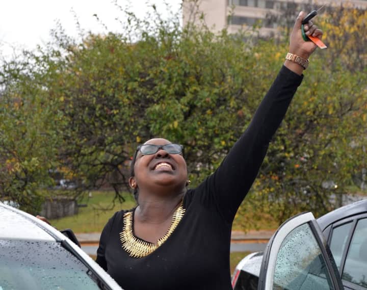 Brianna McCoy reacts with excitement as she receives the keys to a car.