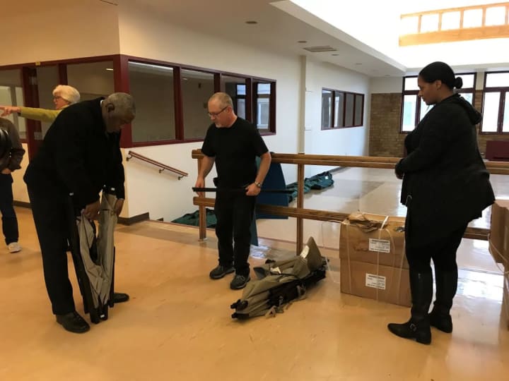 Rockland County DSS staff and Helping Hands officials work together to set up cots at the Warming Center.