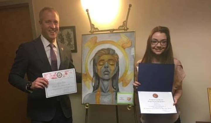 Rep. Sean Patrick Maloney with Alana Green and her painting &quot;Angel.&quot;