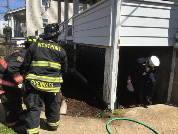 Westport firefighters attack a porch blaze Tuesday morning on Franklin Street.