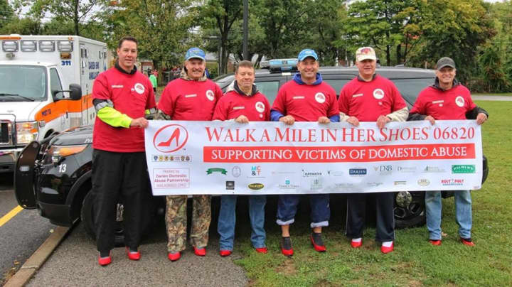 Members of the Darien Police Department walked a mile in red high heels to raise awareness and support victims of domestic violence.