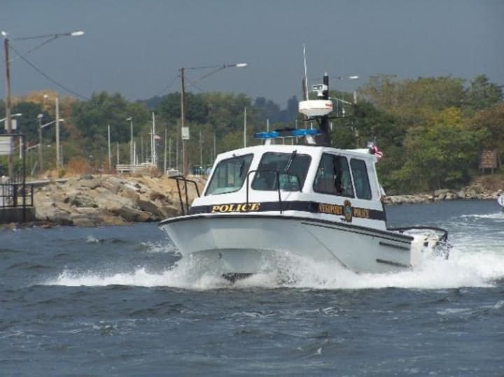 Westport Marine Police rescued three people from a capsized canoe in the waters off Cockenoe Island in Long Island Sound 