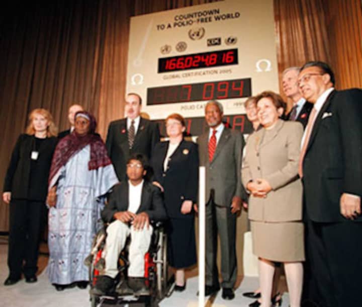 Thaddeus Farrow, in front in wheelchair, appears with then-UN Secretary-General Kofi Annan and other officials at a Polio Partners Summit in 2000 for UNICEF.