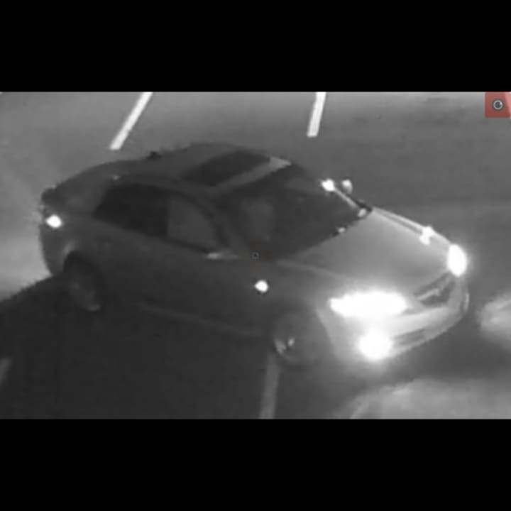 The vehicle appears to be 2014 or 2015 Acura TLX sedan with tinted windows and after market tires and rims.