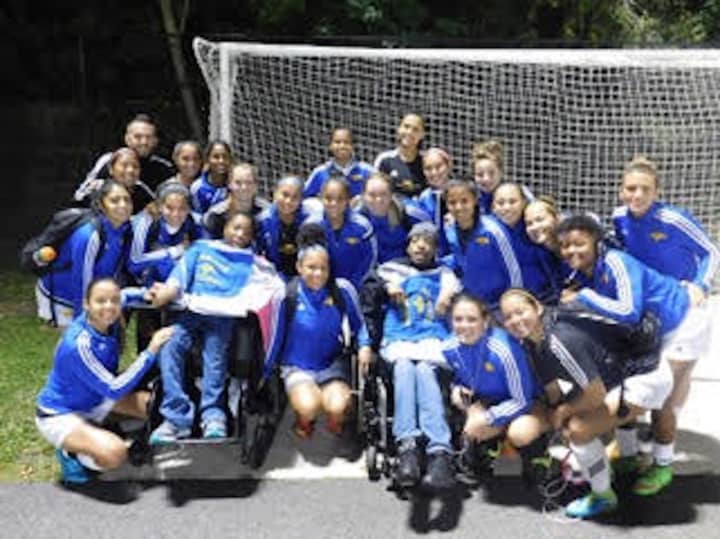 The Monroe College women&#x27;s soccer team with honorary captains from Richmond Community Services. 