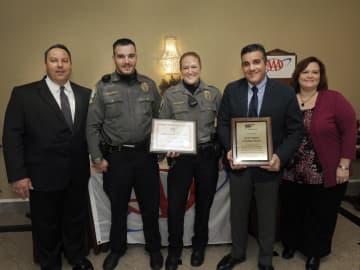 AAA Danbury Branch Manager Christine Lucsky, right, presents the awards to, from left, Newtown Police Lt. Chris Vanghele, police officer Ben Mulhall;  police officer Paul Wickman with her award; and Newtown Police Chief James Viadero.