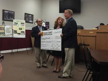Freeholders Pat Lepore and Rhonda Cotroneo present an Open Space check for Walter T. Bergen field improvements to Mayor Dunleavy.