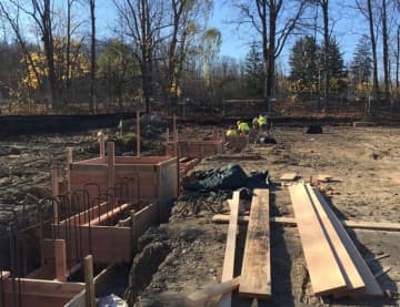 Workers lay the foundation at the site of the new West Milford Township Library.