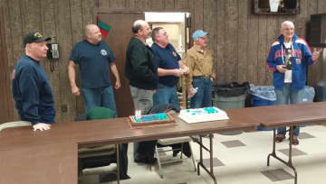 Pompton Lakes firefighters celebrate a milestone for member Albert Backus, at right.
