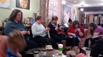 Spinning Yarn Knitters Club members take over the Enchanted Cafe in Red Hook while their regular meeting place at the Red Hook Library is undergoing renovations.