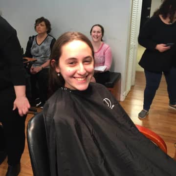 A Frisch School student prepares to donate her hair.