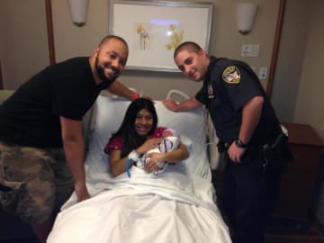 Eastchester first responders with the baby and mother they assisted in the back of a taxi on New Rochelle Road.