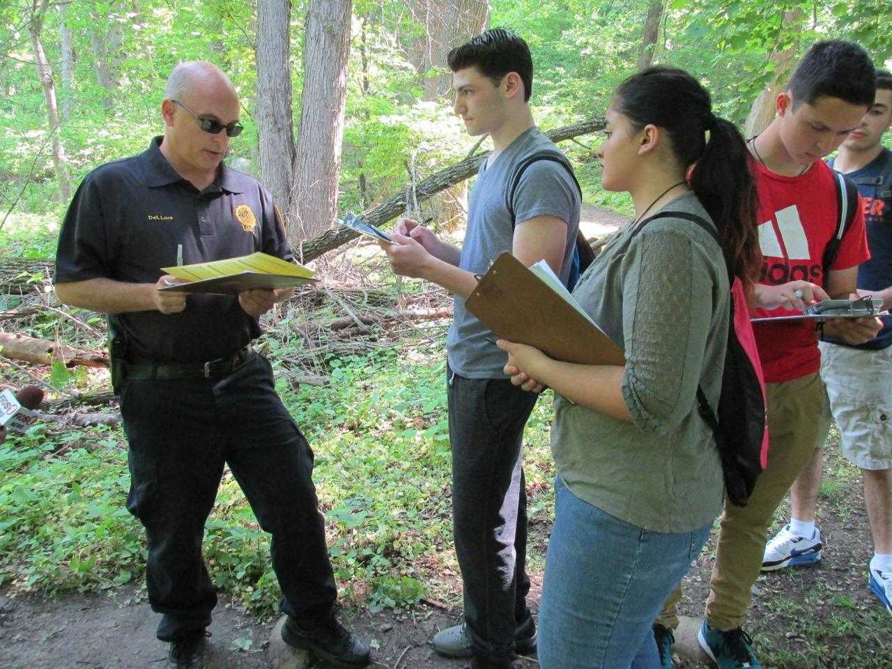 New Rochelle police officers assisted students in Scott Rubins' forensics class.
