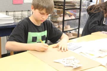 A student designing a canopic jar.