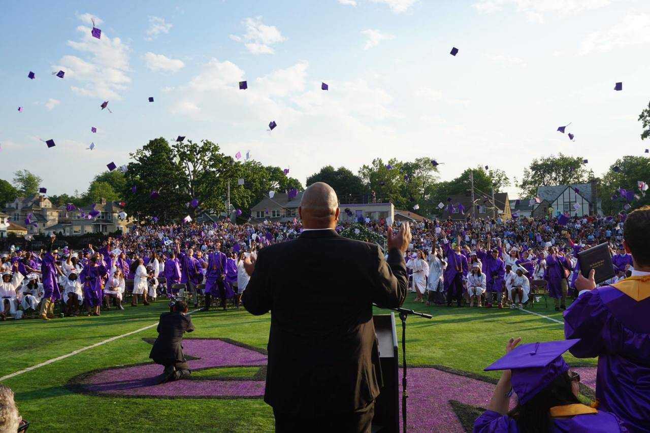 Students throwing their caps in the air in celebration of graduation.