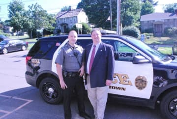 Officer Matthew Hayes meets Rep. Bolinsky with the Ford SUV they will patrol in.