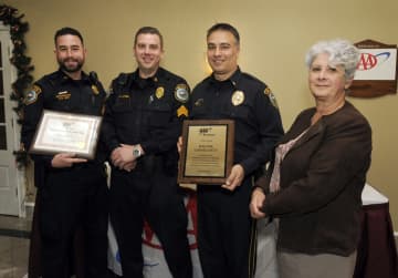 Public Affairs Manager Fran Mayko (right) presents the awards to (from left) Officer Patenude; Sgt. David Hartman, who is a AAA driving improvement instructor; and Lt. Robert Kluk.
