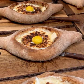 One of Badagenoi's favorite bread, Khachapuri is a dish that's like an open-faced cheese boat with an egg on top.