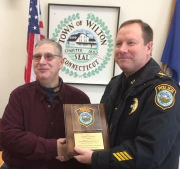 Wilton Police Chief Robert Crosby presents a plaque to Animal Control Officer Robert Napoleon who has retired after 33 years with the Town of Wilton.