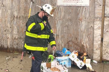 Passaic Battalion Chief John Hayowyk views some of the remains of the afternoon fire.