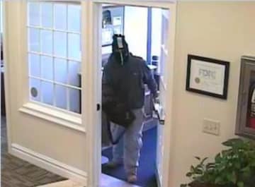 The suspect in the robbery of the Fairfield County Bank on Route 7 in Wilton at the front door.