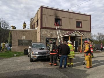 A Good Samaritan and volunteer firefighter showed no hesitation when he rescued a person caught in a blaze above a flea market in Warren County Monday morning.