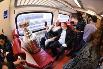 The Stanley Cup rides on a New Haven Line train from New York City to Stamford.