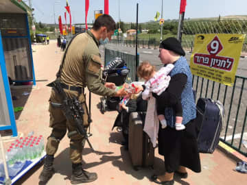An IDF soldier assists those affected by the mass casualty incident on the Jewish holiday of Lag B’Omer at Mt. Meron, in which 45 people were killed.