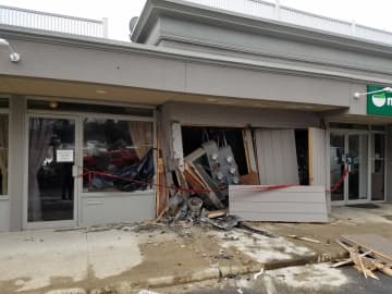 The facade is damaged at Naked Greens on Route 7 in Wilton after a car slammed into the building Saturday.