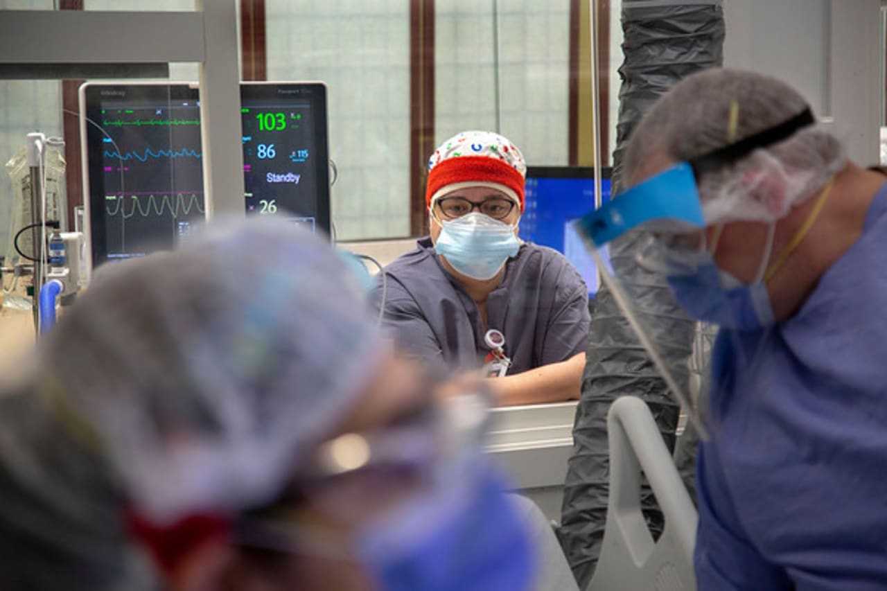 Marilyn Monzon, RN, looks on in a COVID-19 room at Holy Name Medical Center during the first weeks of the COVID-19 Pandemic.
