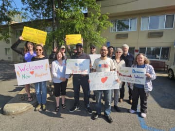 A group of well-wishers welcomed the migrants to the Red Roof Inn in Poughkeepsie.